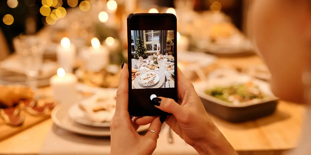 Guest taking a photo of a festive party table with a phone